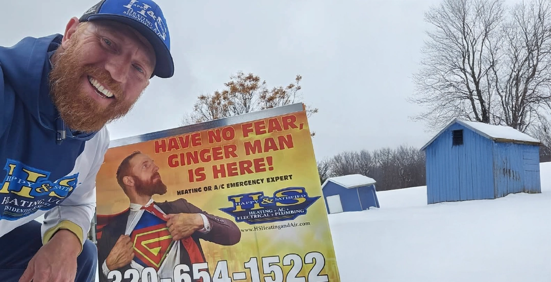 Local plumbing expert Jeremy Salzbrun of H&S Heating and Air Conditioning with his sign outside a Central Minnesota home.