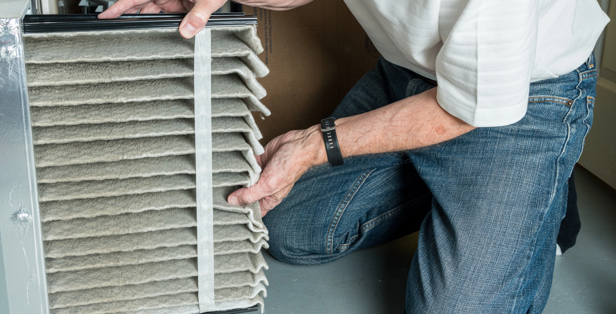 A technician changing a dirty furnace filter.