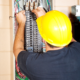 An electrician working on an electrical panel.