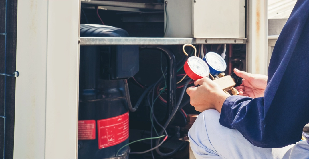 acInspectionLG A technician performing an inspection on an air conditioning unit.