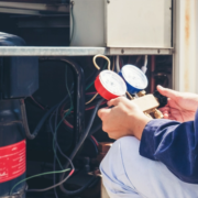 A technician performing an inspection on an air conditioning unit.